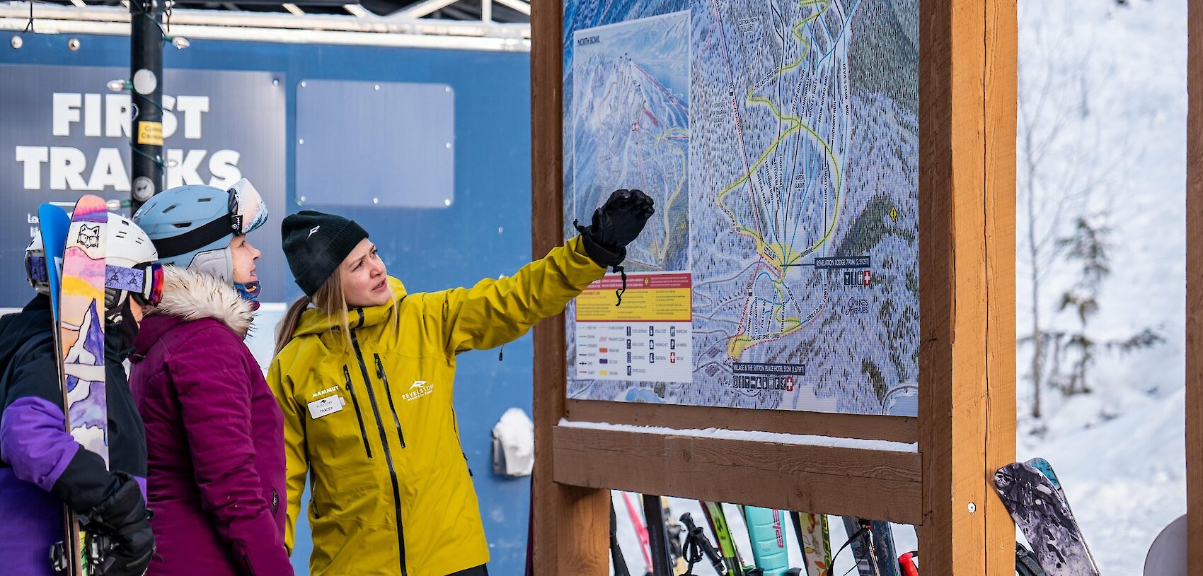 Skiers reviewing a mountain map with an instructor before heading out on the slopes