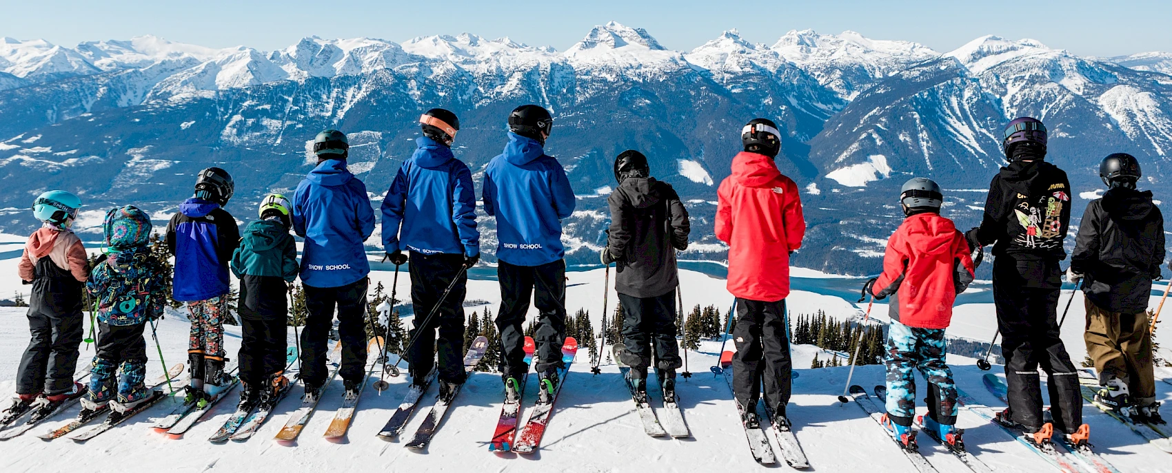 Group of children and instructors looking at a stunning mountain view